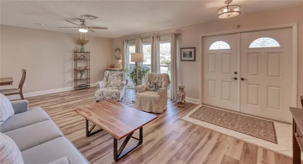 a living room with furniture and wooden floor
