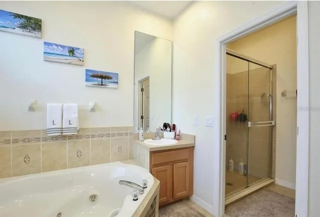 a bathroom with a tub sink and mirror