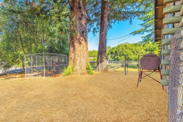 a view of a house with backyard and sitting area