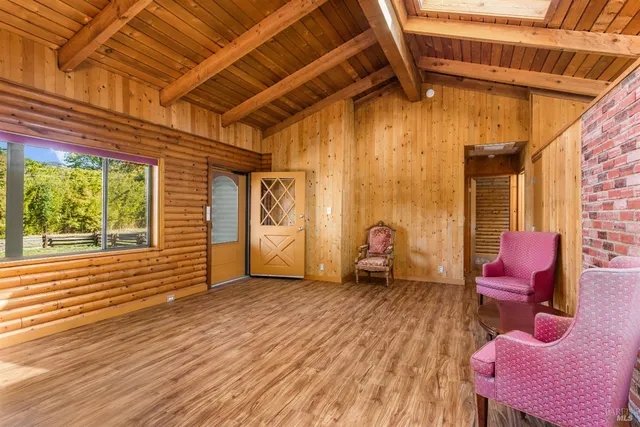 a view of a porch with furniture and a backyard