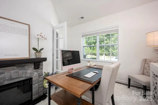 a view of a workspace with a window and a fireplace