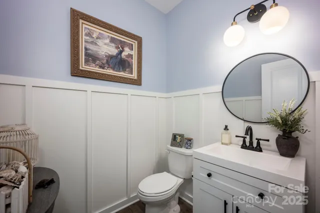 a bathroom with a toilet a sink and a mirror