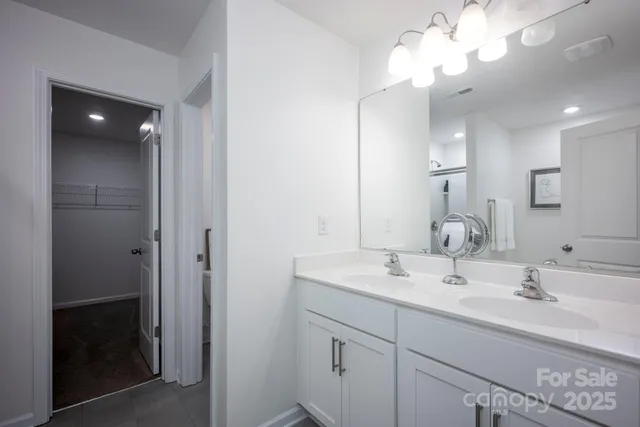 a bathroom with a sink vanity and a mirror