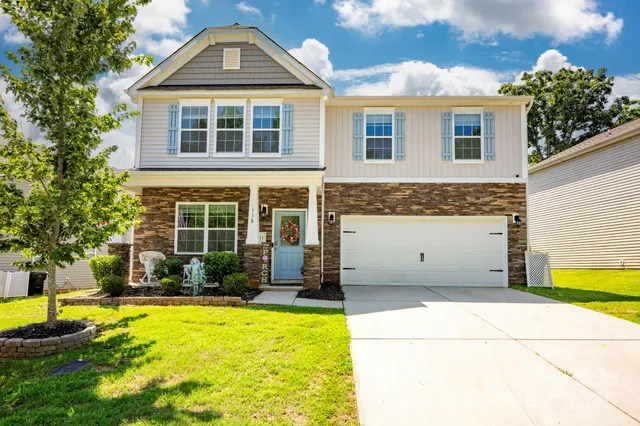 a front view of a house with a yard