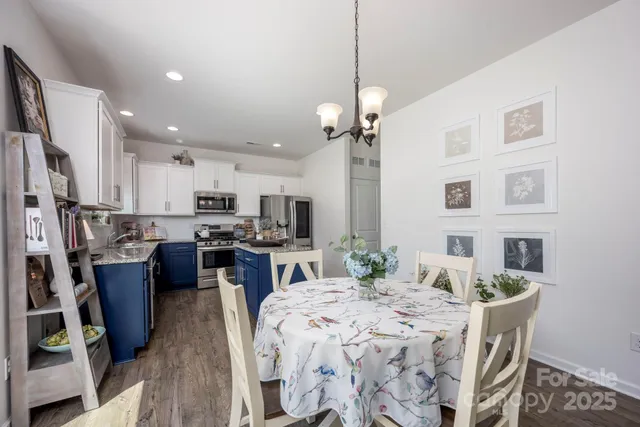 a large kitchen with a table and chairs