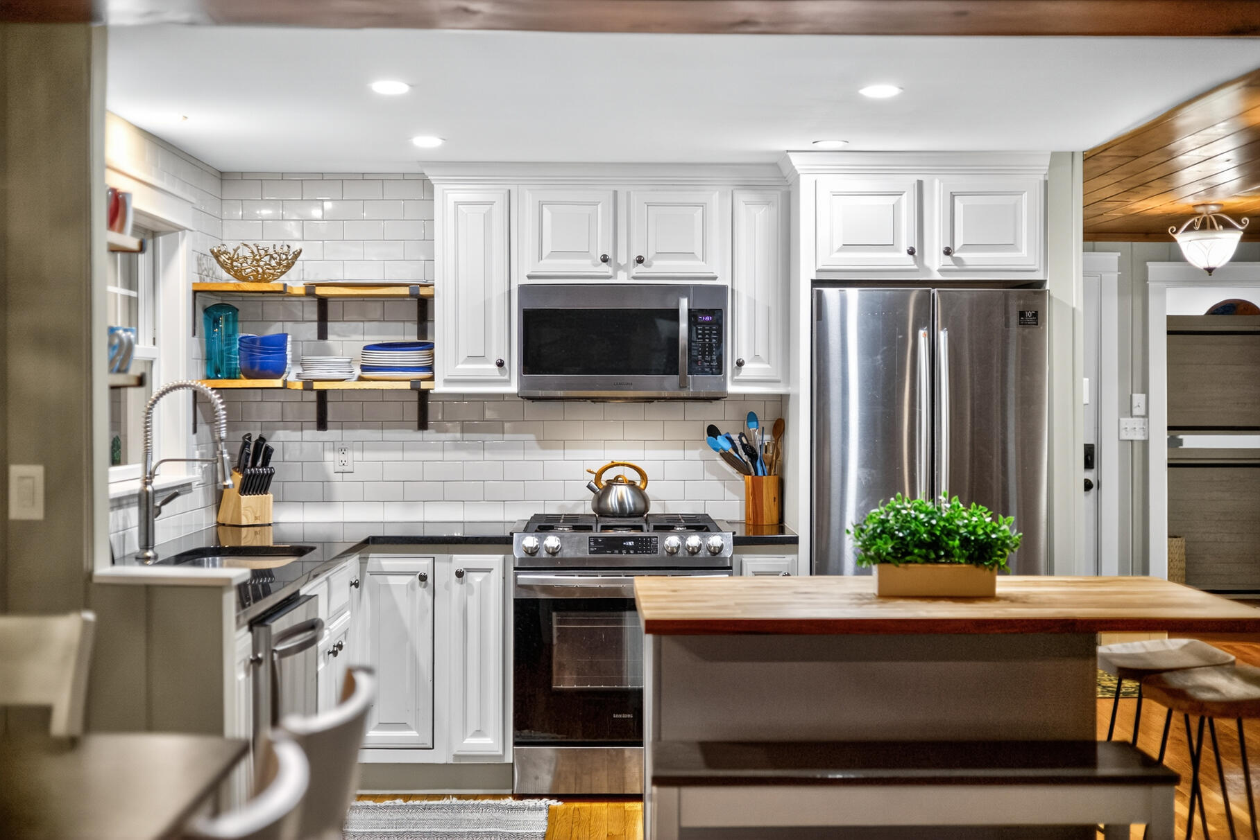 23 Childs River Road East Falmouth, MA 02536 - Photo 12 of 34 a kitchen with stainless steel appliances kitchen island granite countertop a stove a sink and a microwave