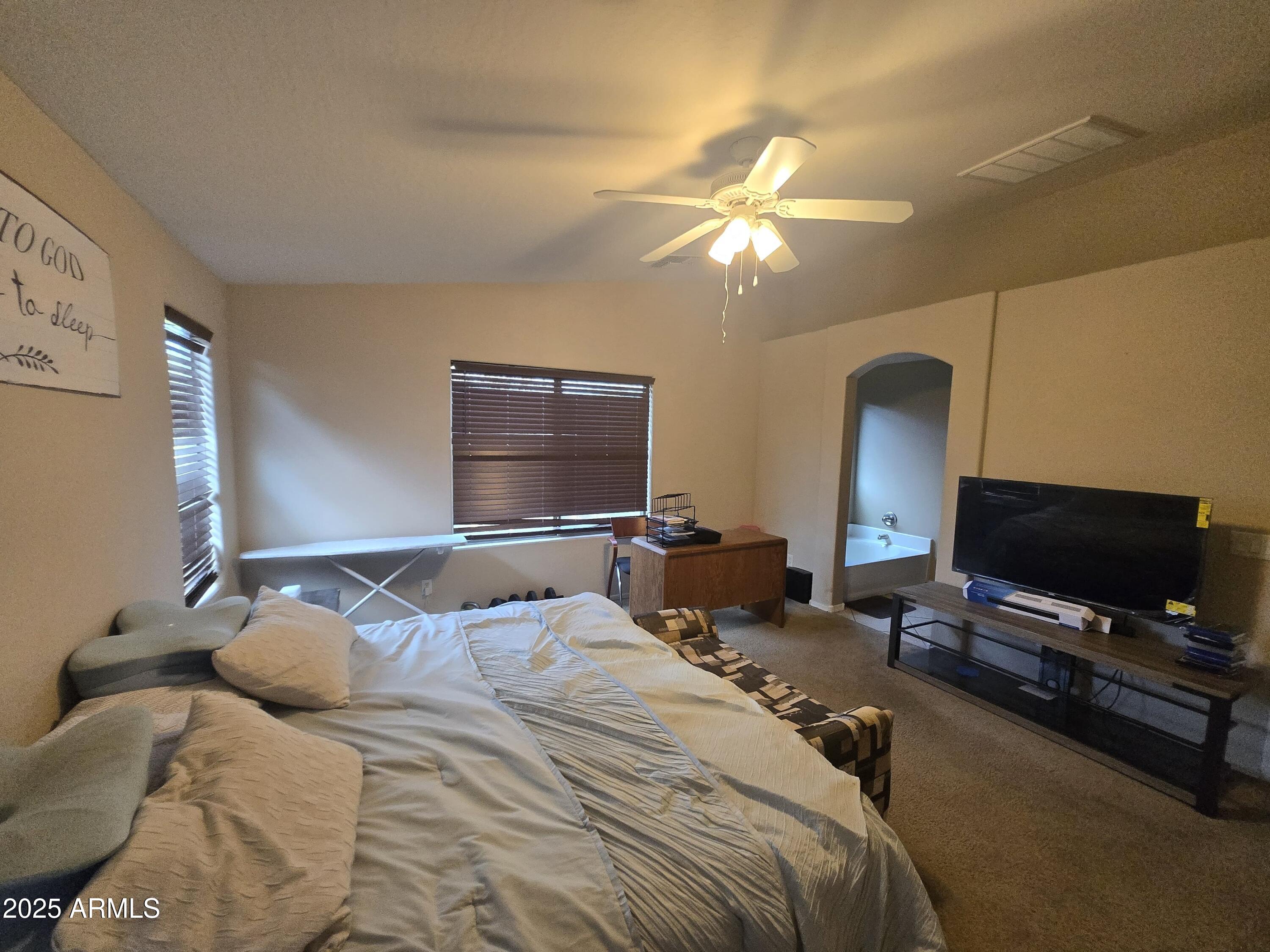 8814 West Magnolia Street Tolleson, AZ 85353 - Photo 16 of 19 a bedroom with a bed and a flat screen tv