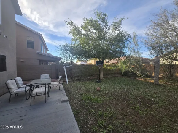 a view of a backyard with large trees