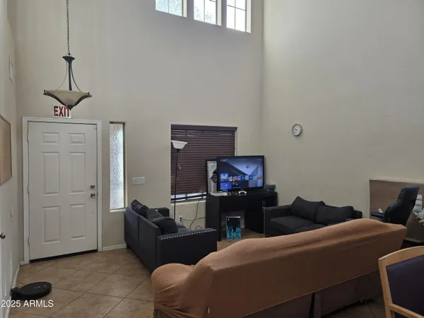a living room with furniture a ceiling fan and a window