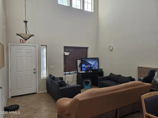 a living room with furniture a ceiling fan and a window