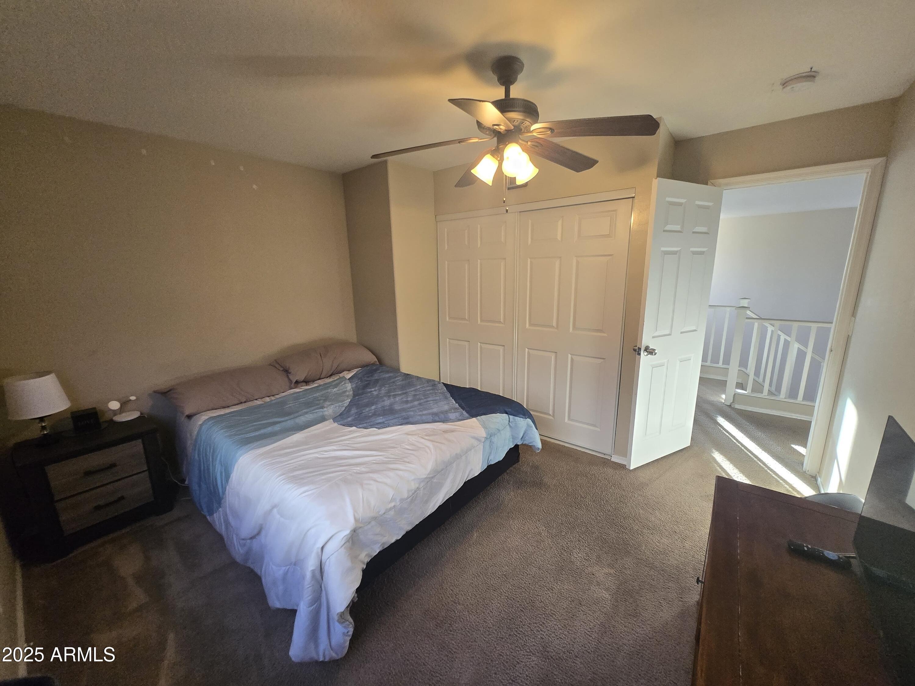 8814 West Magnolia Street Tolleson, AZ 85353 - Photo 10 of 19 a bedroom with a bed and a chandelier
