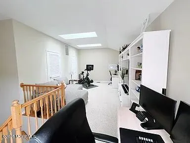 a view of a workspace with furniture and entryway