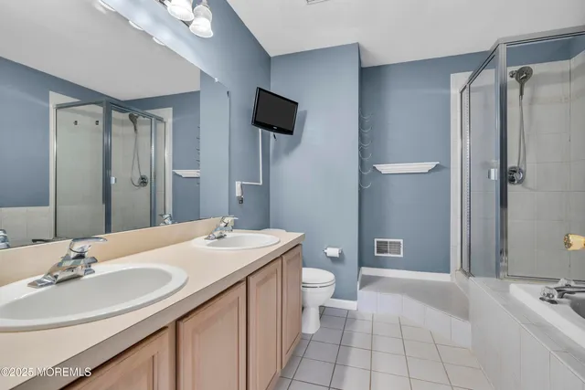 a bathroom with a sink a toilet and mirror