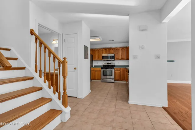 a view of a kitchen with wooden floor and electronic appliances