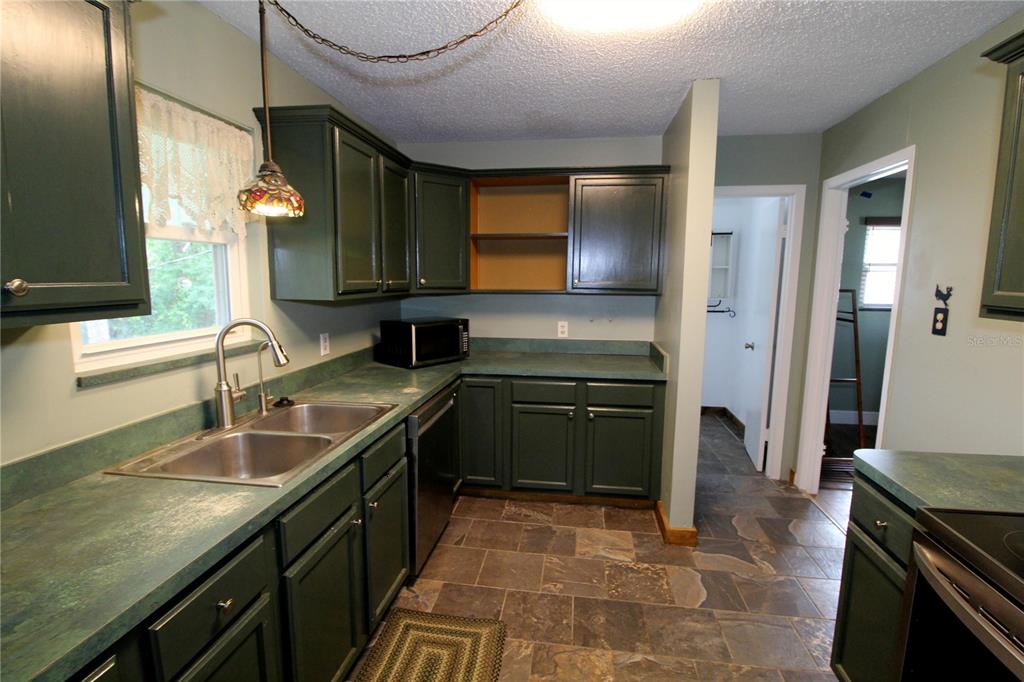 14712 Henson Road Orlando, FL 32832 - Photo 11 of 32 a kitchen with a sink stove and refrigerator