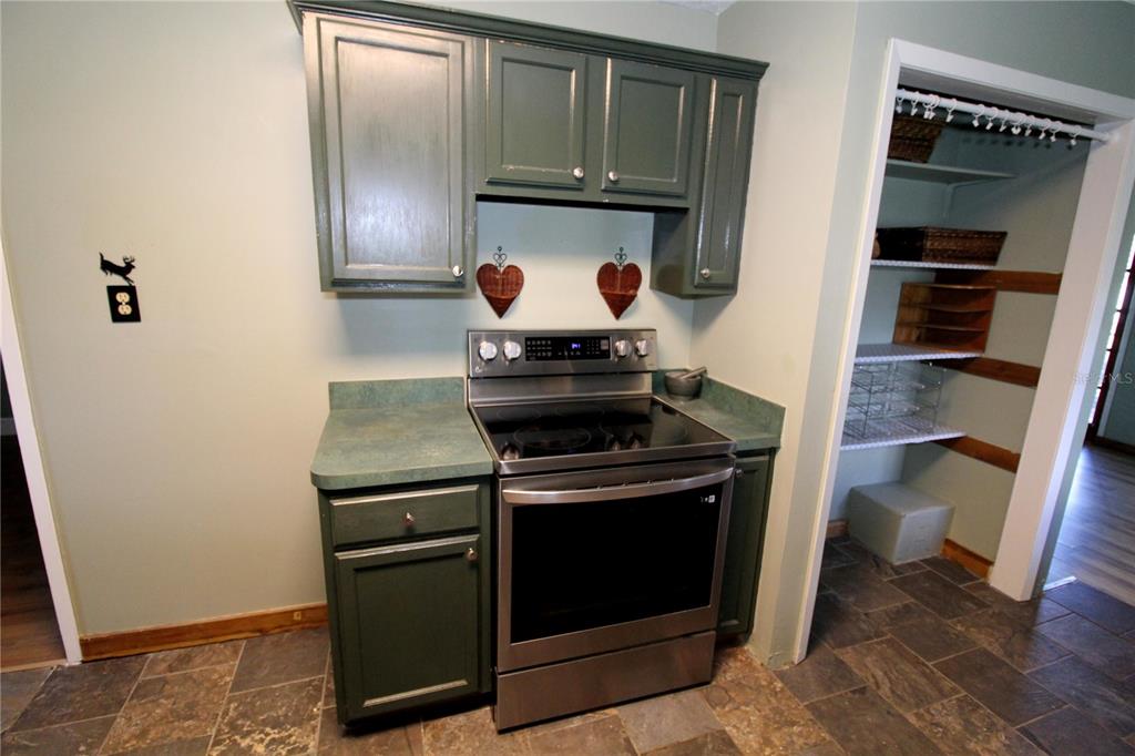 14712 Henson Road Orlando, FL 32832 - Photo 12 of 32 a stove top oven sitting inside of a kitchen