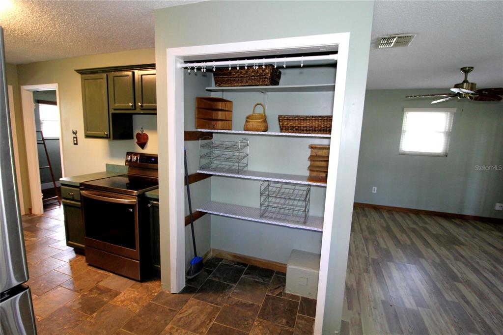 14712 Henson Road Orlando, FL 32832 - Photo 13 of 32 a kitchen with a refrigerator and a stove top oven