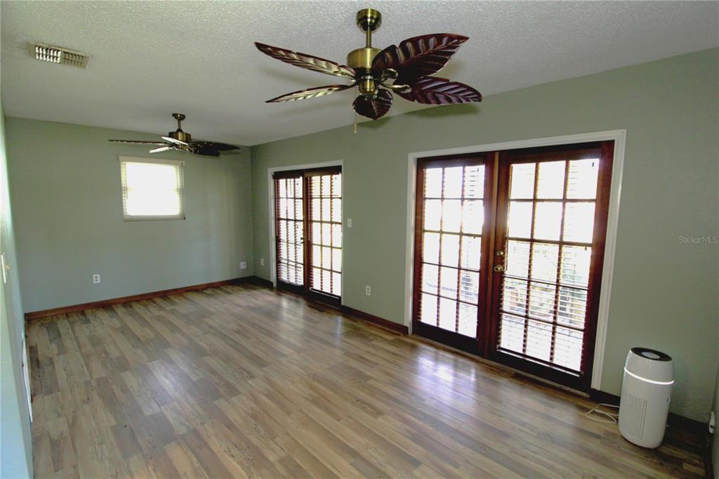14712 Henson Road Orlando, FL 32832 - Photo 14 of 32 a view of an empty room with a window and wooden floor