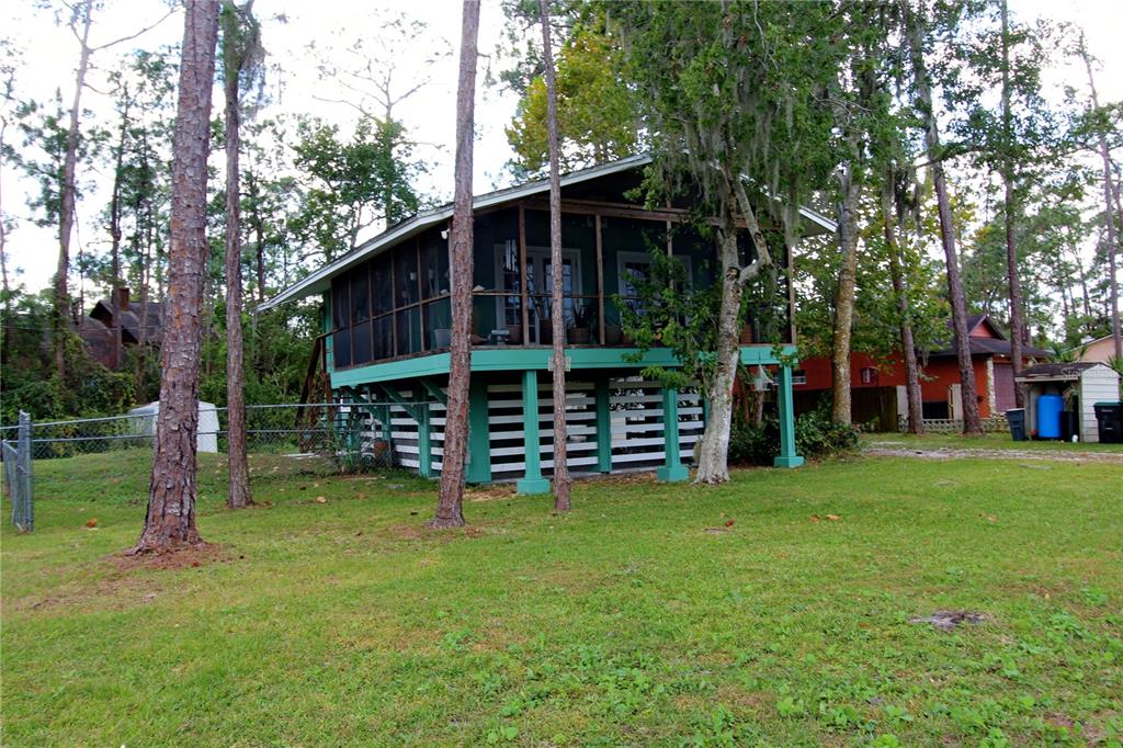 14712 Henson Road Orlando, FL 32832 - Photo 2 of 32 a view of a house with backyard and trees