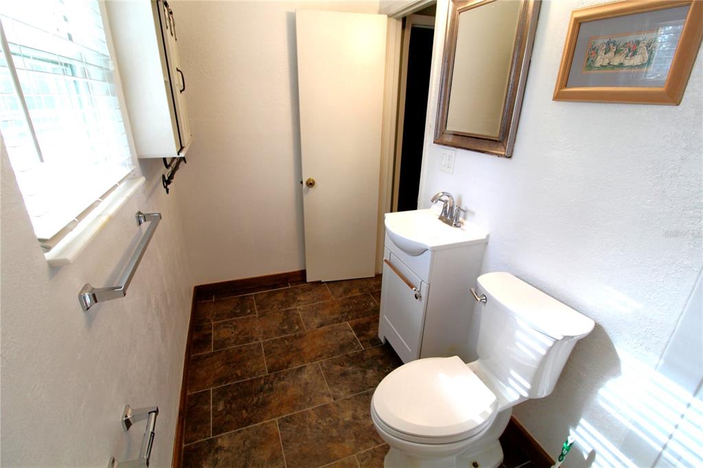 14712 Henson Road Orlando, FL 32832 - Photo 21 of 32 a white toilet sitting next to a bathroom sink