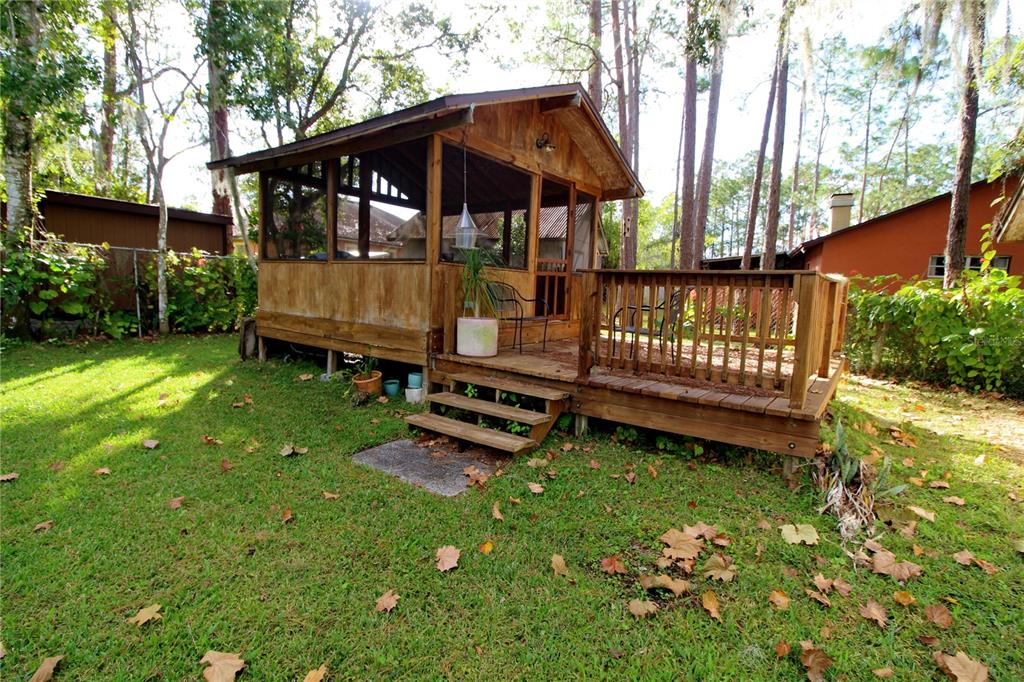 14712 Henson Road Orlando, FL 32832 - Photo 28 of 32 a view of a small yard with wooden deck and furniture