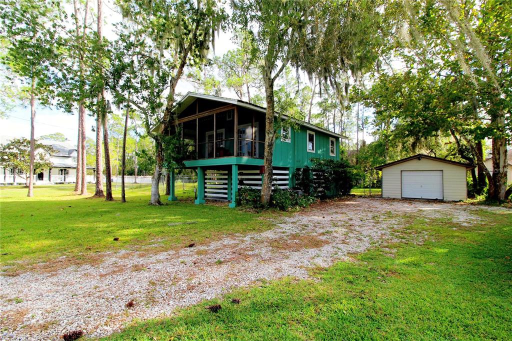 14712 Henson Road Orlando, FL 32832 - Photo 3 of 32 a front view of a house with garden