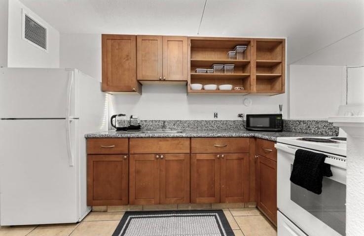 111 Kahului Beach Road, Unit B112 Kahului, HI 96732 - Photo 3 of 15 a kitchen with stainless steel appliances granite countertop a refrigerator and a stove top oven