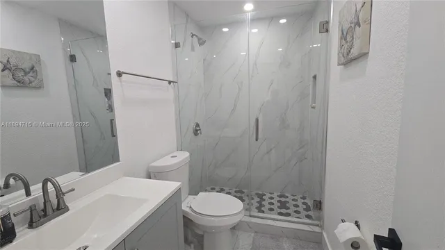 a bathroom with a sink toilet and shower