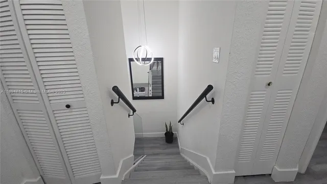 a view of a hallway with stairs