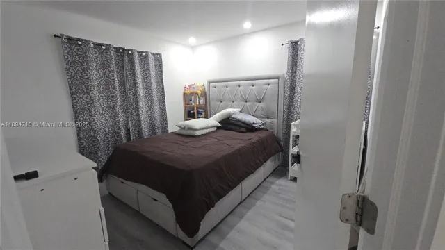 a bedroom with a bed and a walk in closet