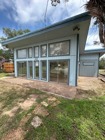 a view of a house with a yard and a garage