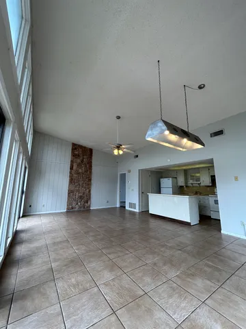 a view of a livingroom with a ceiling fan and window