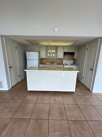 a view of a kitchen with microwave and cabinets