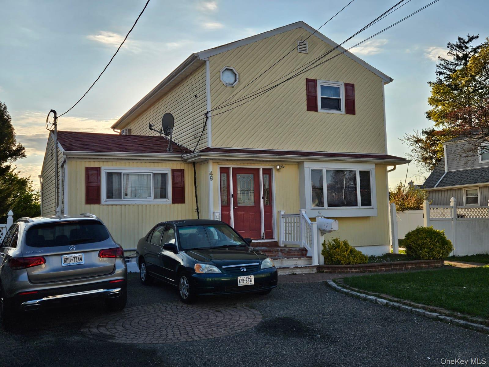 49 Volta Street Copiague, NY 11726 - Photo 1 of 9 a car parked in front of a house