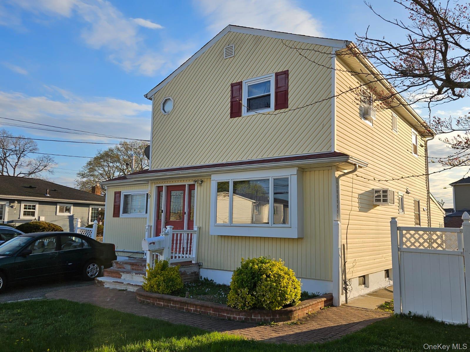 49 Volta Street Copiague, NY 11726 - Photo 2 of 9 a front view of a house with garden
