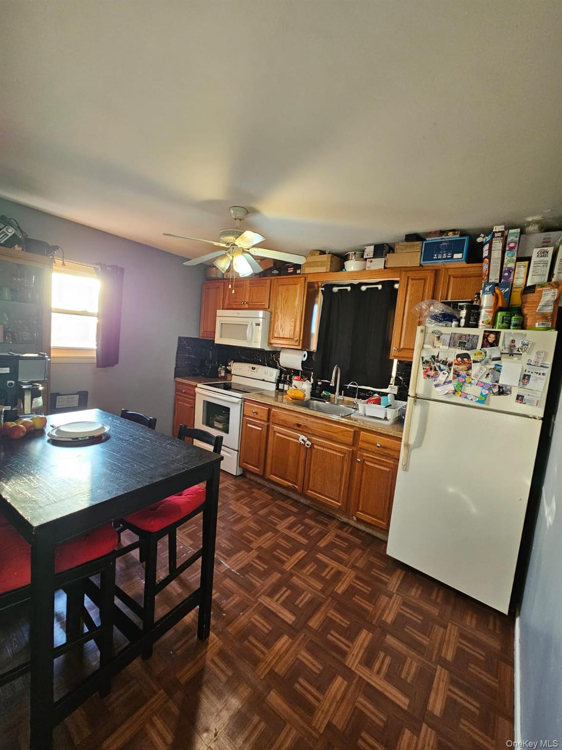 49 Volta Street Copiague, NY 11726 - Photo 7 of 9 a kitchen with a sink a stove and chairs