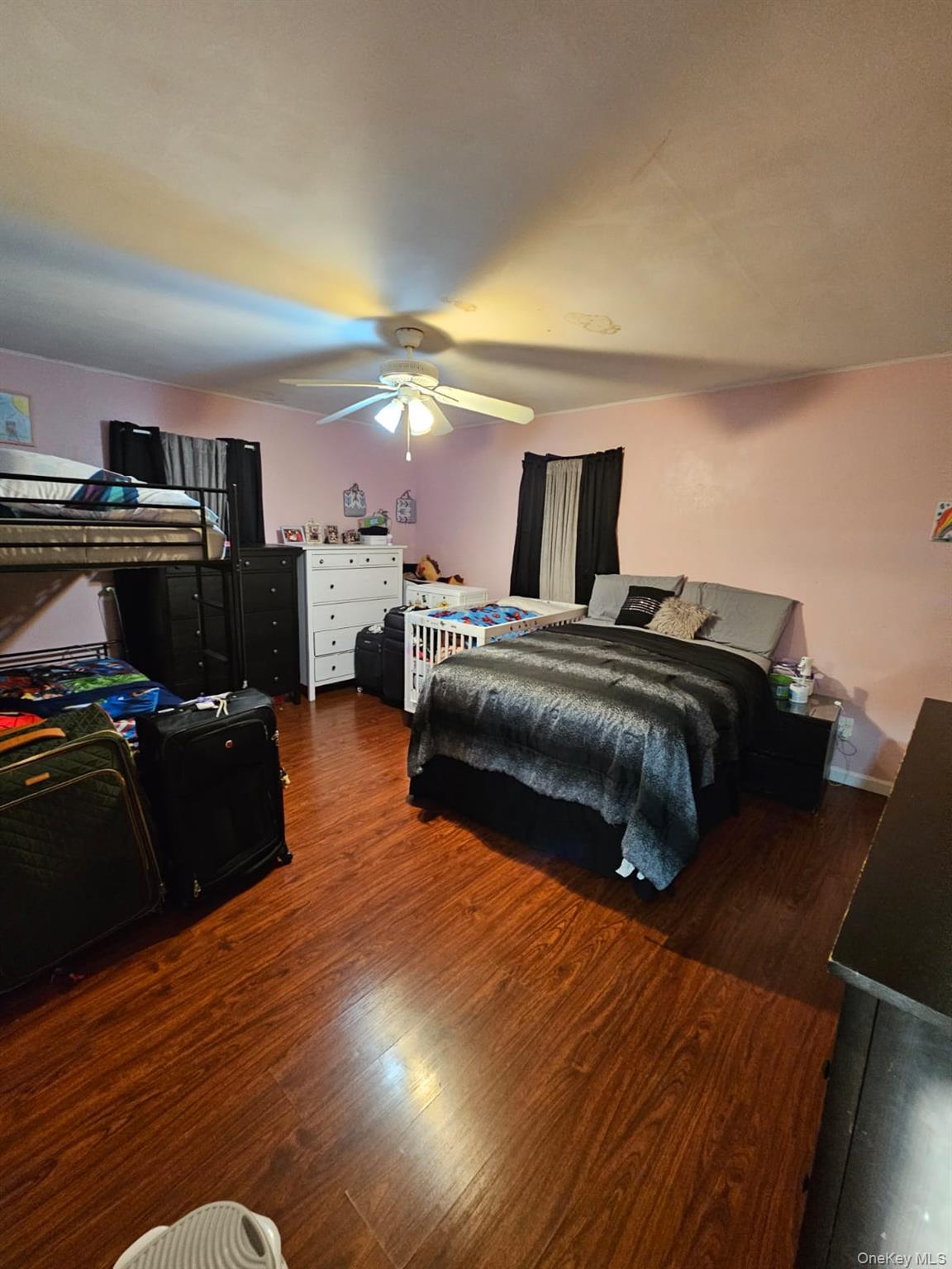 49 Volta Street Copiague, NY 11726 - Photo 9 of 9 a bedroom with a bed and wooden floor