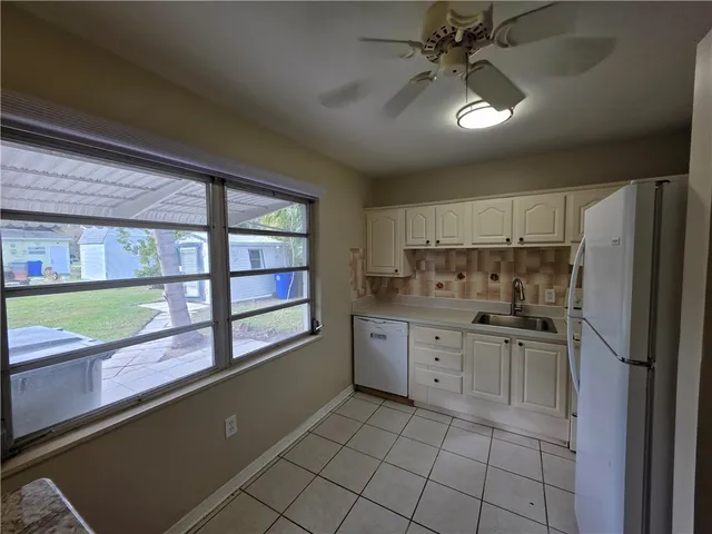 a kitchen with granite countertop a cabinets and a stainless steel appliances