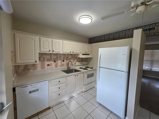 a kitchen with stainless steel appliances a refrigerator sink and cabinets