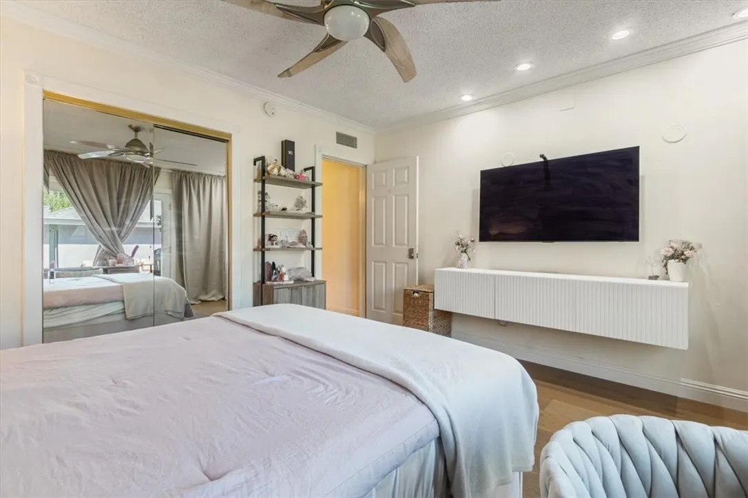 15657 Devonshire Street Granada Hills, CA 91344 - Photo 13 of 39 a bedroom with a bed and a television