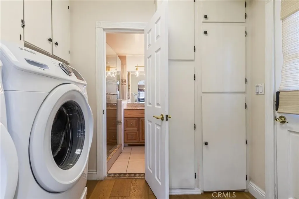 15657 Devonshire Street Granada Hills, CA 91344 - Photo 18 of 39 a view of a hallway with washer and dryer