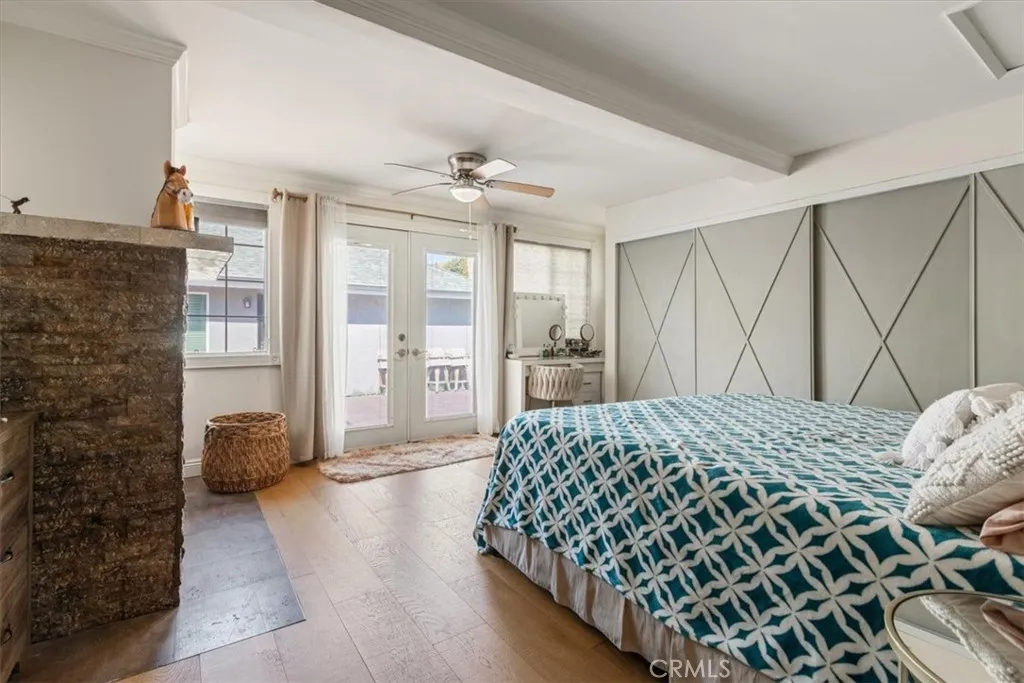 15657 Devonshire Street Granada Hills, CA 91344 - Photo 19 of 39 a bedroom with a bed and glass walk in closet