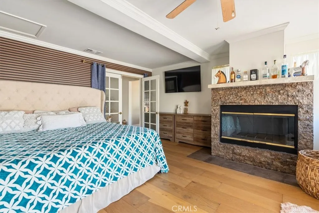 15657 Devonshire Street Granada Hills, CA 91344 - Photo 20 of 39 a bedroom with a bed and a fireplace