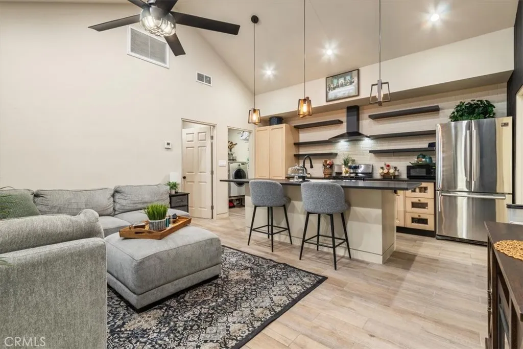15657 Devonshire Street Granada Hills, CA 91344 - Photo 22 of 39 a living room with stainless steel appliances furniture a rug and a kitchen view