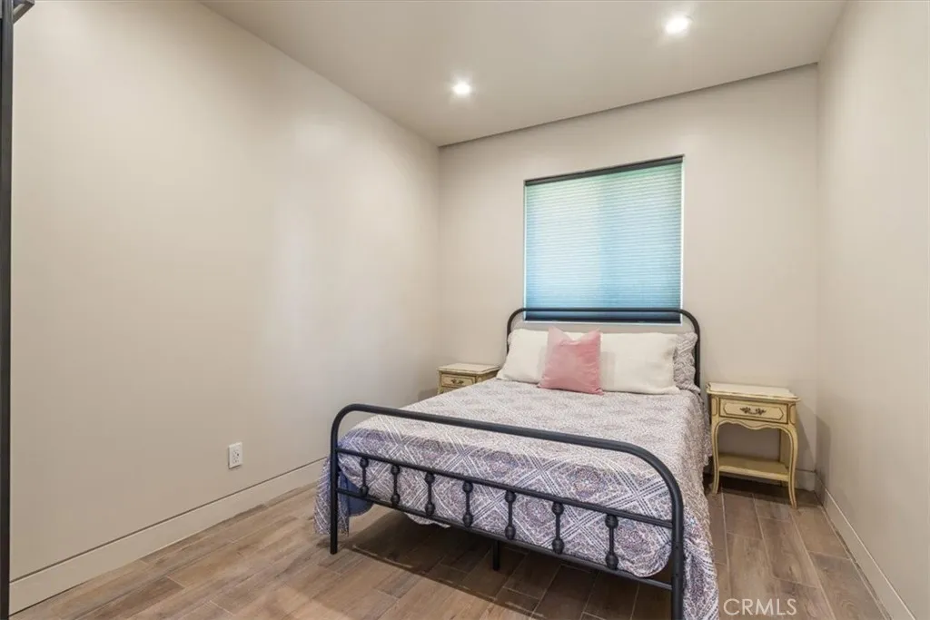 15657 Devonshire Street Granada Hills, CA 91344 - Photo 30 of 39 a bedroom with a bed and a night stand