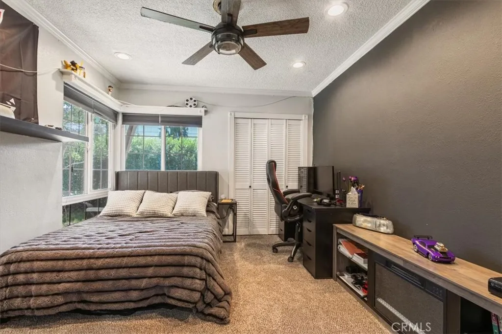 15657 Devonshire Street Granada Hills, CA 91344 - Photo 5 of 39 a bedroom with a bed and a chandelier