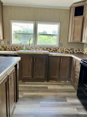 a view of granite countertop a sink and a stove