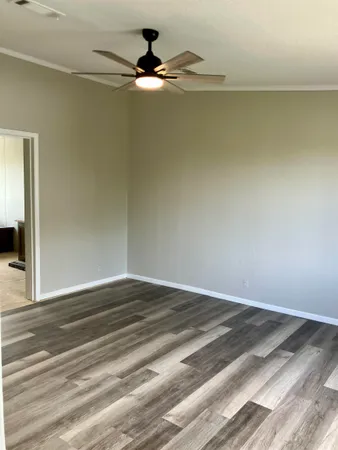 a view of a room with wooden floor and fan