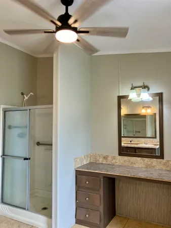 a bathroom with a granite countertop sink mirror and