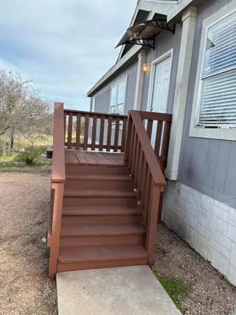 a view of entryway with wooden floor and a front door